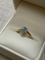 10K Yellow gold Blue Topaz .06tw Diamond Ring